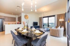 Deluxe Apartment | Living area | 55-inch LED TV with satellite channels