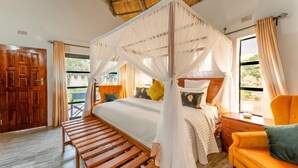 A bedroom with a wooden bed, a canopy bed, a wooden bench, and a yellow armchair.