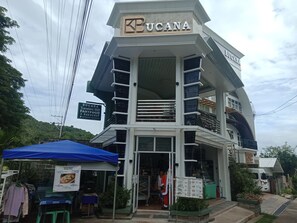 A multi-story building with a prominent 'BUCANA' sign at the top. - Bucana (Guinsiliban)