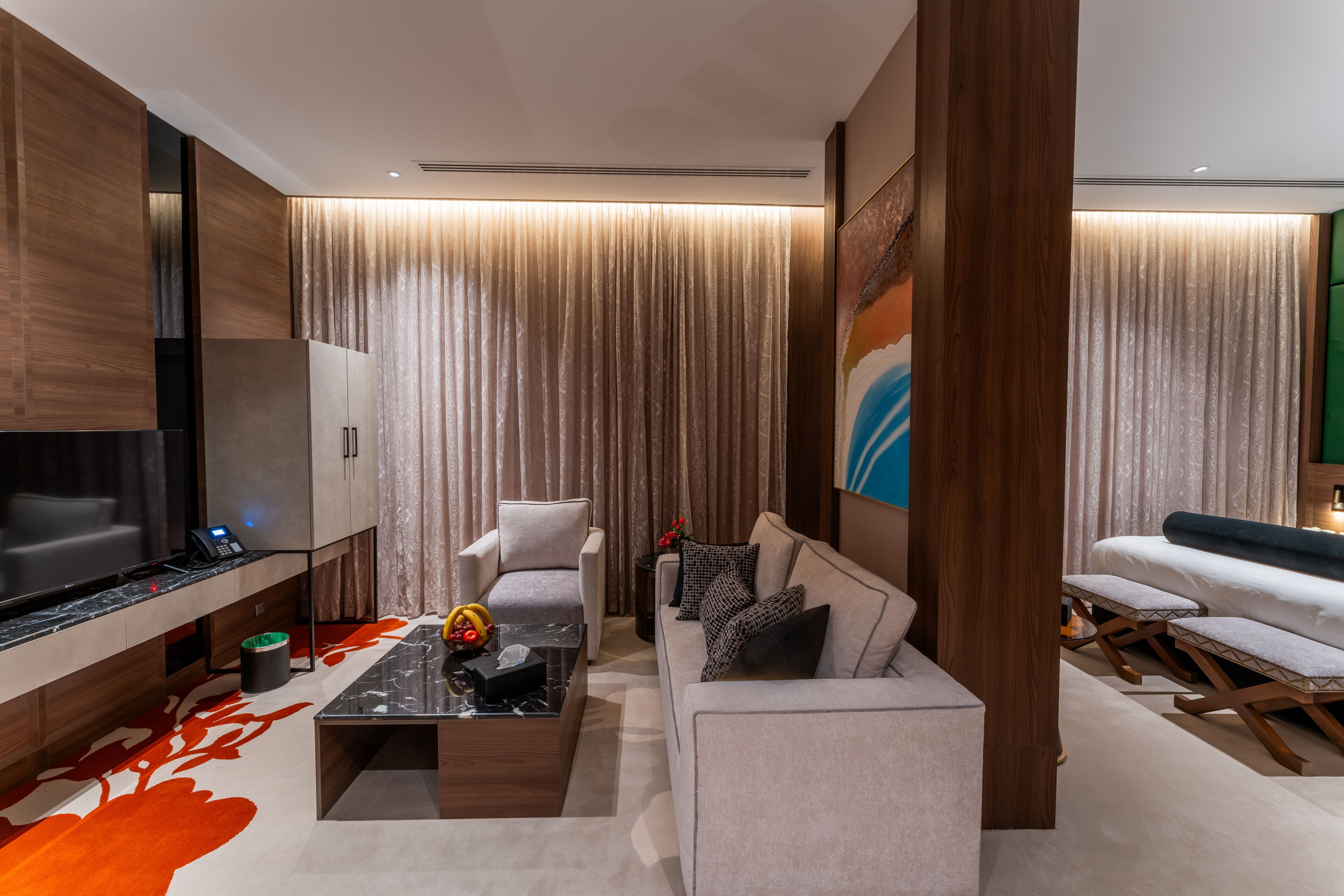 A modern living room with a sofa, coffee table, and a TV.