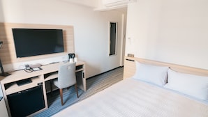 A hotel room with a bed, a desk with a computer, a chair, and a flat-screen TV. -  Quintessa Hotel Chiba Funabashi (Funabashi)