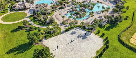 A golf course with a large pool area, multiple buildings, and well-maintained landscaping.