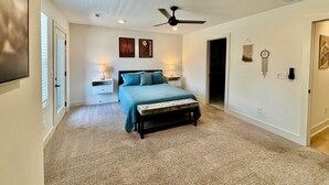 A bedroom with a bed, nightstands, a ceiling fan, and wall decorations. - Air-hockey garage game room, 3 queen bedrooms, sleeps 10 — 5 min to BNA, near Opry Mills (Nashvillle)
