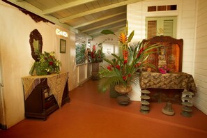 Stroll through a beautifully landscaped corridor lined with lush plants and decorative elements.