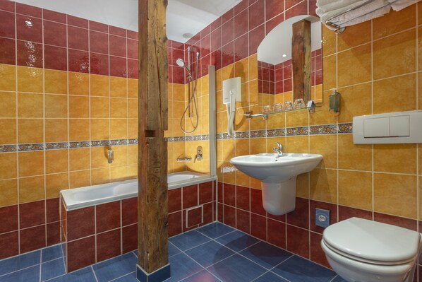 A bathroom with a bathtub, sink, and toilet.