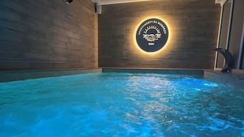 Indoor pool, open 9:00 AM to 7:00 PM, pool loungers