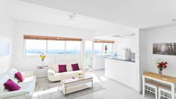 Comfort Apartment | Living area | 60-inch Smart TV with cable channels