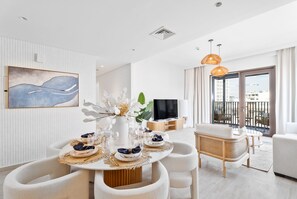 Design Apartment | Living area | 55-inch Smart TV with cable channels - Nasma Holiday Homes - Breeze at Creek Beach (Dubai)