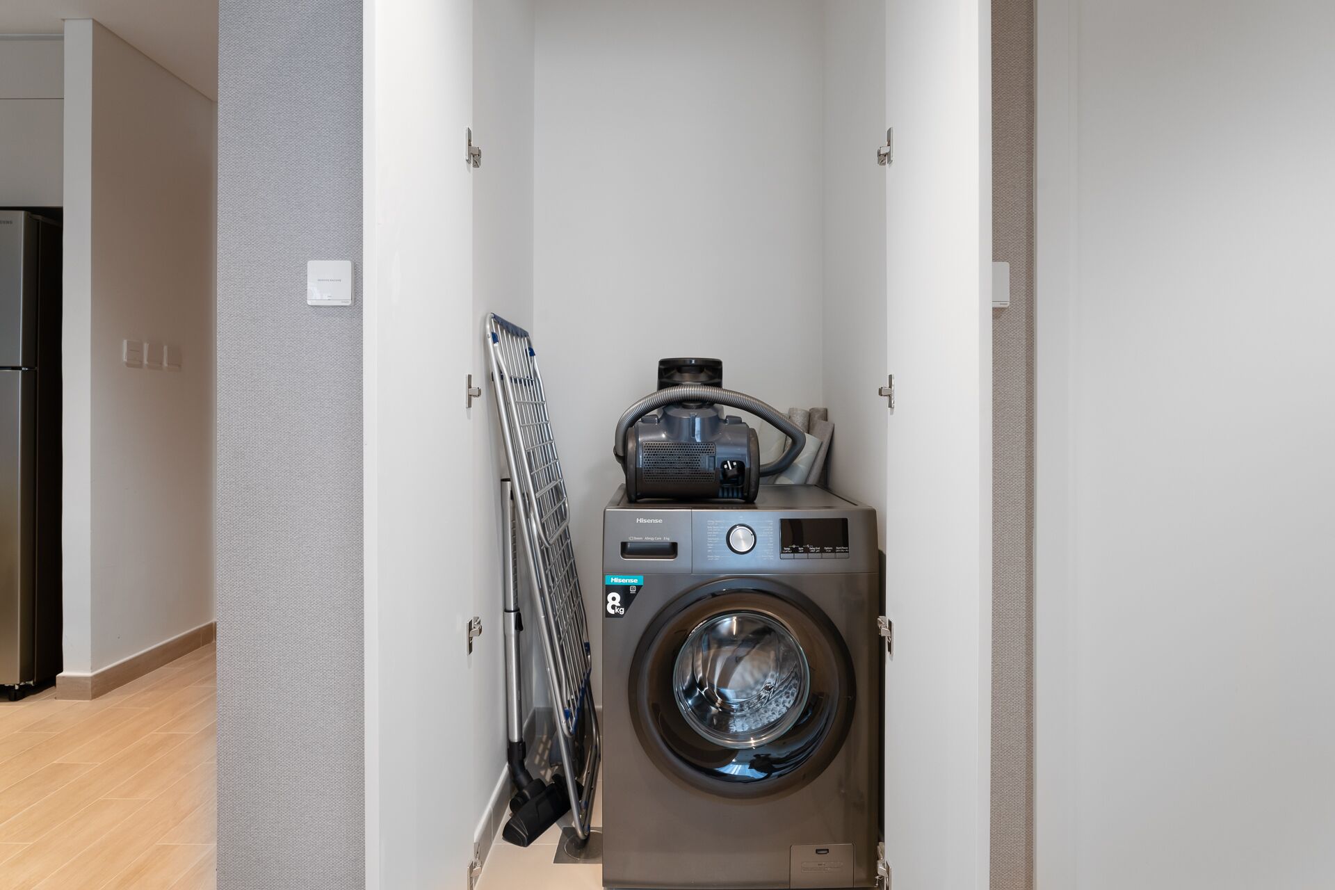 A compact laundry room with a front-loading washing machine and a drying machine.