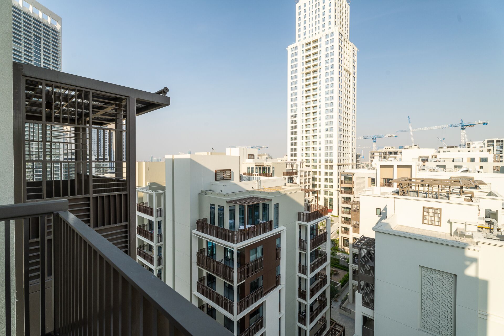 A high-rise residential building with multiple balconies and a modern architectural design.
