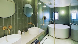 A modern bathroom with two sinks, a large bathtub, and a glass-enclosed shower area. - Portside Inn Hakodate (Hakodate)