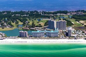 A coastal hotel complex with multiple high-rise buildings, a beach, and surrounding greenery. - Chick and Dudes Beach Escape 2 Bedroom Condo by RedAwning (Miramar Beach)