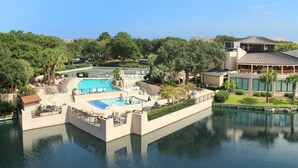 A resort with a large pool area, a separate pool, and a building with a sloped roof. - 1501 Island Club - Folly Field - 2 Bed 2 Bath Sleeps 4 - Hilton Head Rentals (Hilton Head island)