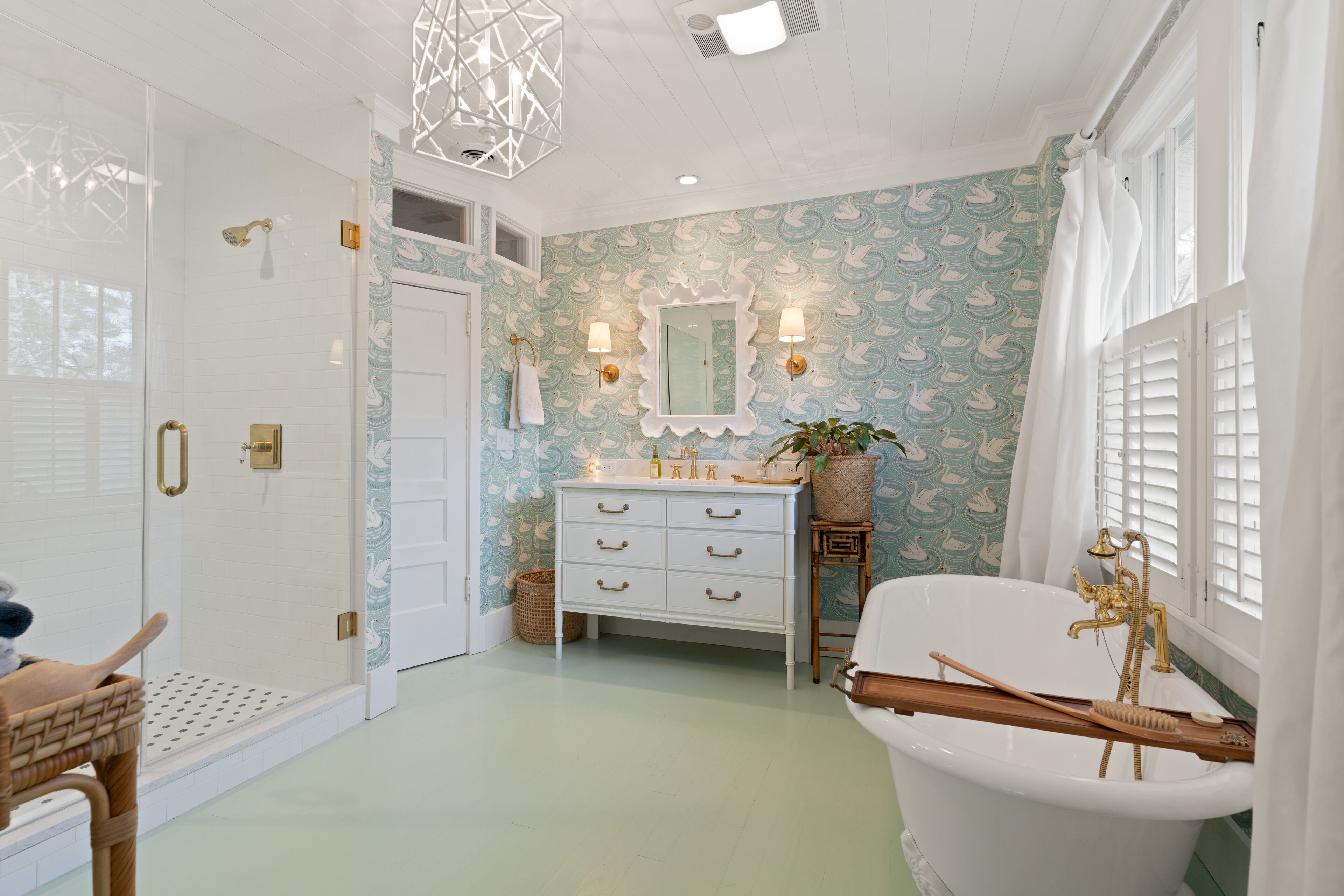 Une salle de bain équipée d’une douche, d’une baignoire, d’un meuble-lavabo avec un miroir et d’un évier.