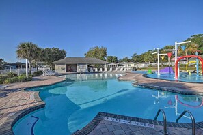 A swimming pool with a lifeguard stand, lounge chairs, and a covered area. - 455 Pampas, 3 bedroom with 2 bathrooms (Surfside Beach)