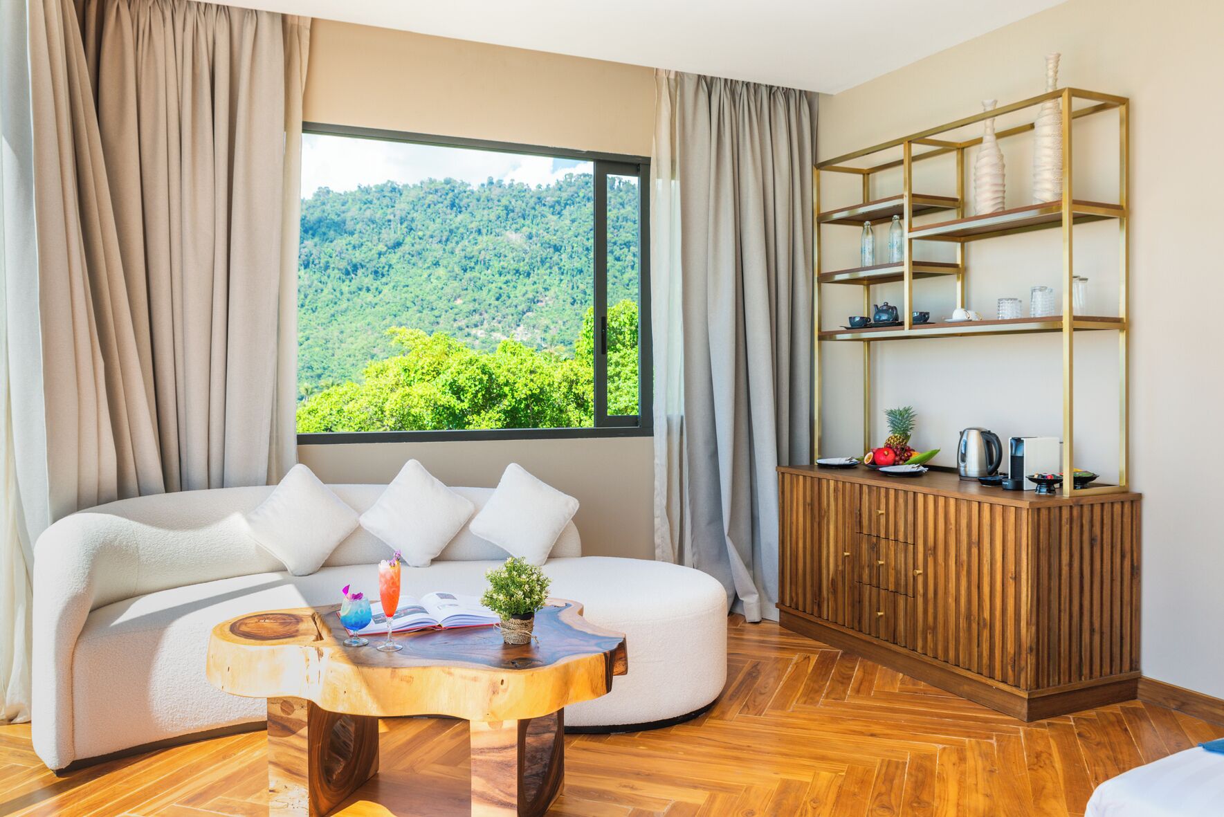 A modern room with a sofa, a wooden coffee table, a cabinet with shelves, and a large window with a view of greenery.