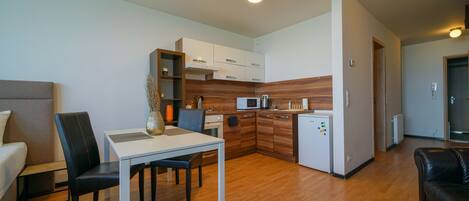 Flora Cozy Apartment by CHORS | Private kitchen | Fridge, microwave, oven, stovetop