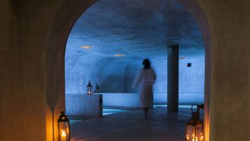 Walking towards a tranquil water feature, guests may enjoy the warm ambiance of this historic corridor.
