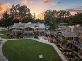 A large, multi-story building with a spacious lawn and a patio area.