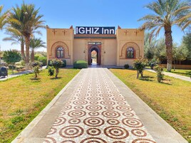 La entrada al IGHIZ Inn, con un camino empedrado que lleva a la recepción.