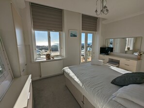 2 habitaciones, escritorio y tabla de planchar con plancha