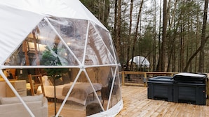 A transparent dome tent with a wooden deck, a sofa, and a hot tub. - "The Perch" RRG - Modern Elevated Stay w/ Hot Tub (Campton)