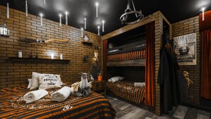 Ein Zimmer mit Backsteinwand, einem Bett mit gestreifter Bettwäsche, einer Kristallleuchter und einem Poster an der Wand.