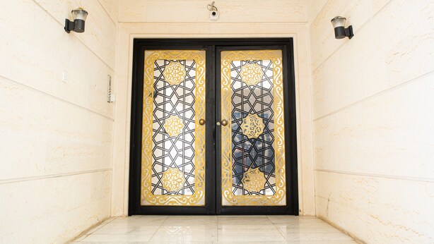 A double door with intricate geometric patterns and a black frame.
