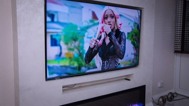 A flat-screen TV mounted on a wall above a fireplace. - Stunning 2-bed Apartment in London (London)