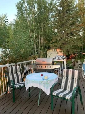 Enjoy al fresco dining on the deck surrounded by lush trees, with a barbecue grill at your fingertips.