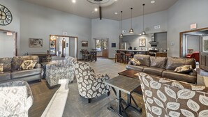A spacious living area with multiple seating options, a dining area, and a kitchen. - Modern spacious 5 bedroom, 3.5 bath, paved roads, hot tub, wifi, pool access (Lead)