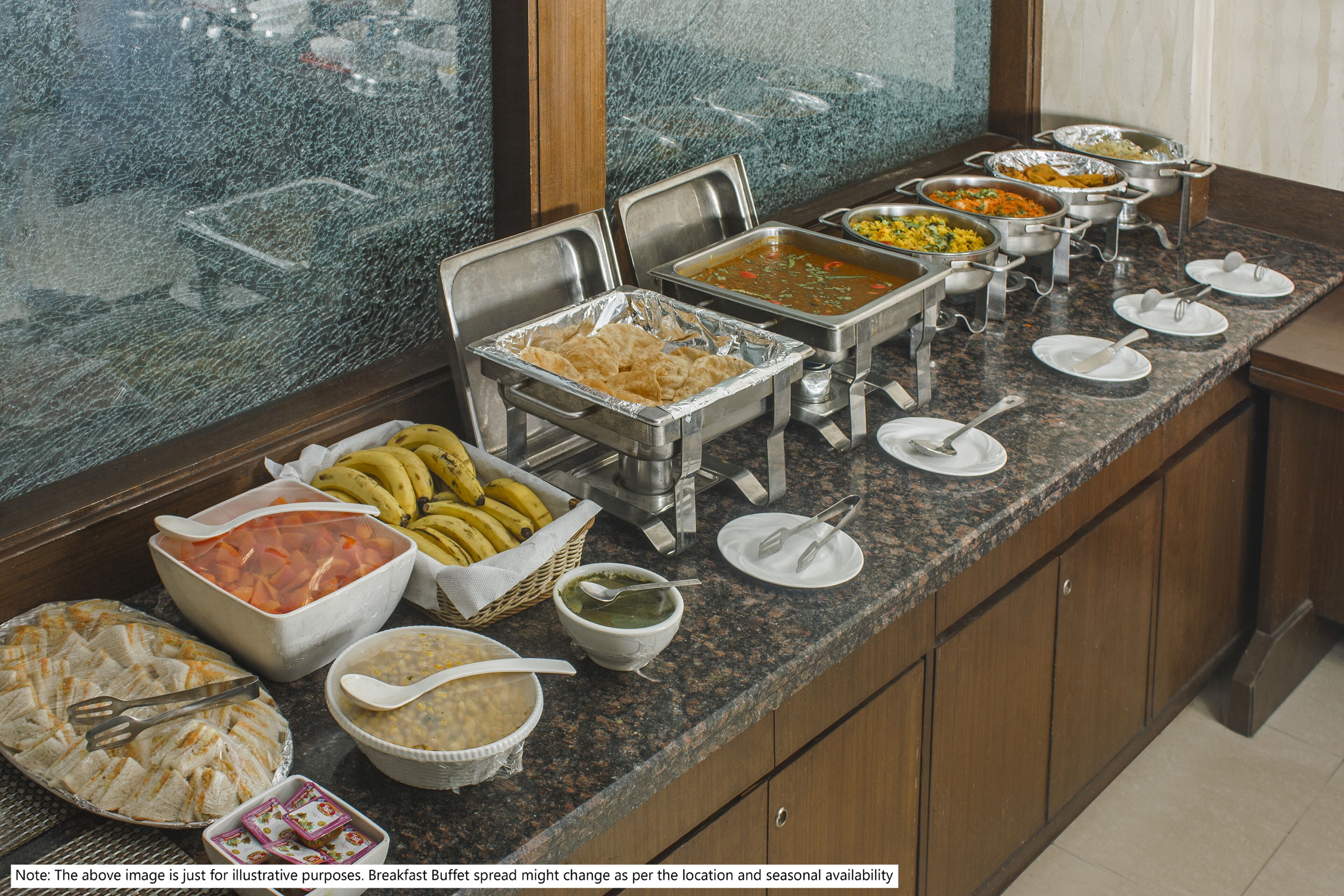 A buffet with various food items and serving utensils.