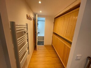 Stylish hallway leads to a bathroom.