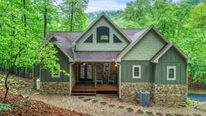 A house with a stone foundation, a wooden deck, and a porch with chairs. - Luxury Mountain Lodge • 4BR • Pool Table + PS5 • Fireplace • Views (McGaheysville)