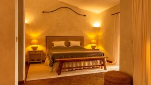 A bedroom with a bed, bedside lamps, a bench, and a nightstand. - Villa 'Acula' with Sea View, Wi-Fi and Air Conditioning (Cannigione)