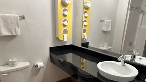 A modern bathroom with a toilet, sink, and towel hooks. - Motel 6 Sullivan, MO (Sullivan)