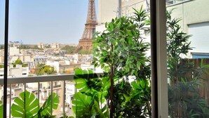 A balcony with a view of the Eiffel Tower and surrounding buildings. - Top Floor Eiffel Tower View and High-speed Wi-Fi (Paris)