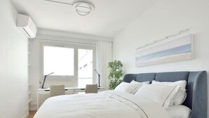 A modern hotel room with a large bed, a desk, and a window. - Top Floor Eiffel Tower View and High-speed Wi-Fi (Paris)
