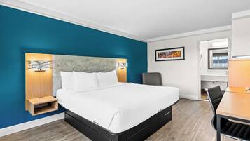 Una habitación de hotel moderna con una cama grande, un escritorio y una silla.