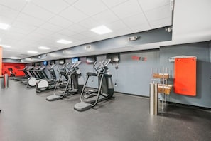 A gym with multiple treadmills and exercise equipment.