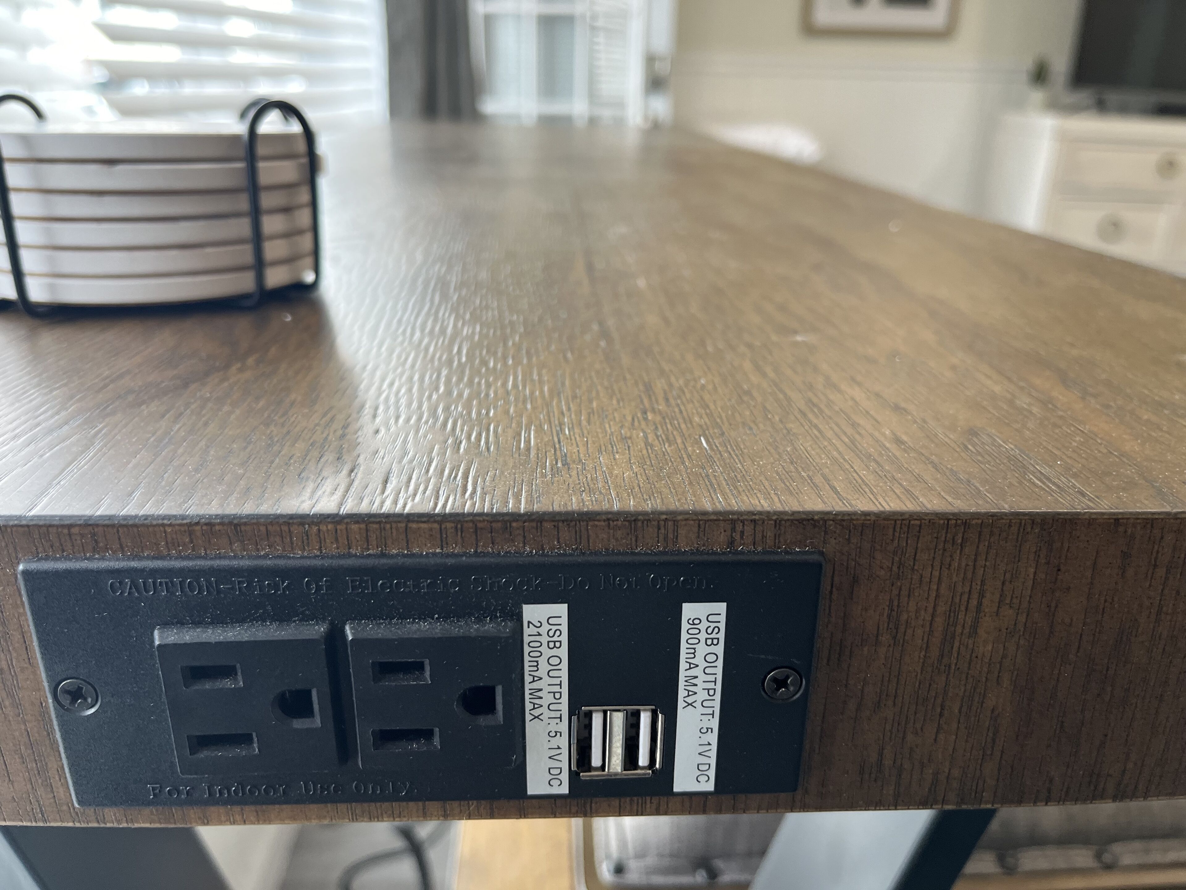 Ein Holztisch mit USB-Ausgang und Steckdose.