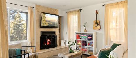 Smart TV, fireplace, books, computer monitors