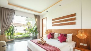 A modern hotel room with a large bed, a view of the outdoors, and a balcony with plants. - Luxury 4BR Haven, Steps to Canggu's Beach Elegance (Canggu)