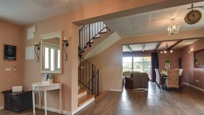 A spacious living area with a staircase, a dining area, and a large mirror. - Villa mit Klimaanlage und Pool (Krnica)