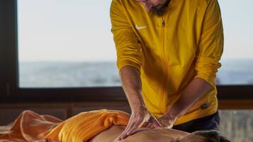 Experience a rejuvenating massage in a serene room with a view of the outdoors.
