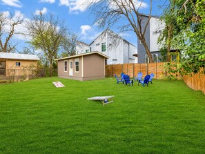 A backyard with a small shed, a picnic table, and blue chairs. - Lone Star Fiesta with Game Room Near Alamodome Ultimate Retreat for Fun & Rel... (San Antonio)