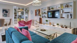 A modern living room with a sofa, chairs, a coffee table, and a TV. - Villa with heated pool (Premantura)