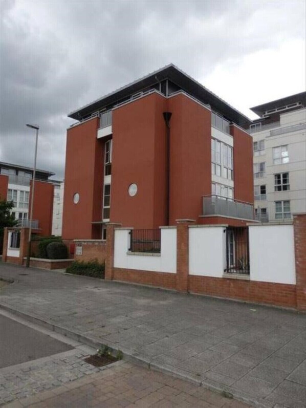 Stylish building with a central balcony and large windows.