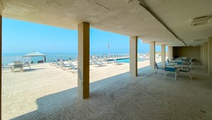 A covered outdoor area with a view of the beach and ocean. - GULF-FRONT VIEW, POOL, HEART OF GULF SHORES! (Gulf Shores)
