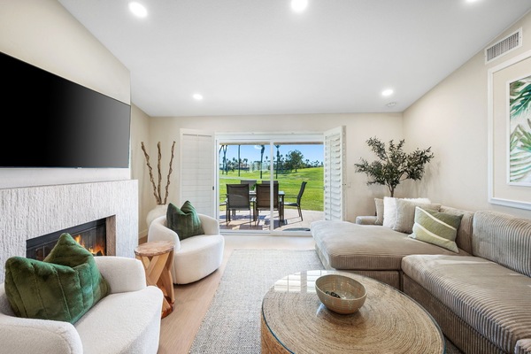 Spacious living area features an oversized, ultra-comfy sectional, smart TV.